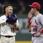 
              Milwaukee Brewers' Kolten Wong (16) laughs with St. Louis Cardinals' Tommy Edman (19) after hitting a double during the eighth inning of a baseball game Tuesday, Sept. 21, 2021, in Milwaukee. (AP Photo/Aaron Gash)
            