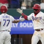 
              Texas Rangers' Andy Ibanez (77) and Adolis Garcia, right, celebrate a two-run home run by Garcia that also scored Ibanea in the fifth inning of a baseball game against the Los Angeles Angels in Arlington, Texas, Thursday, Sept. 30, 2021. (AP Photo/Tony Gutierrez)
            
