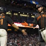 
              San Francisco Giants' LaMonte Wade Jr., left, celebrates with Brandon Crawford after both scored on a two-run single by Curt Casali during the fourth inning of the team's baseball game against the Atlanta Braves in San Francisco, Saturday, Sept. 18, 2021. (AP Photo/Jeff Chiu)
            