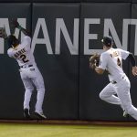 
              Oakland Athletics center fielder Starling Marte (2) cannot catch a double hit by Seattle Mariners' Mitch Haniger next to right fielder Chad Pinder (4) during the fifth inning of a baseball game in Oakland, Calif., Monday, Sept. 20, 2021. (AP Photo/Jeff Chiu)
            