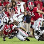 
              Georgia running back Zamir White (3) is tackled by South Carolina defensive back R.J. Roderick (10) and defensive back Jaylan Foster (12) during the first half of an NCAA college football game Saturday, Sept. 18, 2021, in Athens, Ga. (AP Photo/Butch Dill)
            