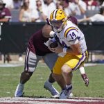 
              LSU quarterback Max Johnson (14) is sacked by Mississippi State defensive end Aaron Odom during the first half of an NCAA college football game, Saturday, Sept. 25, 2021, in Starkville, Miss. (AP Photo/Rogelio V. Solis)
            