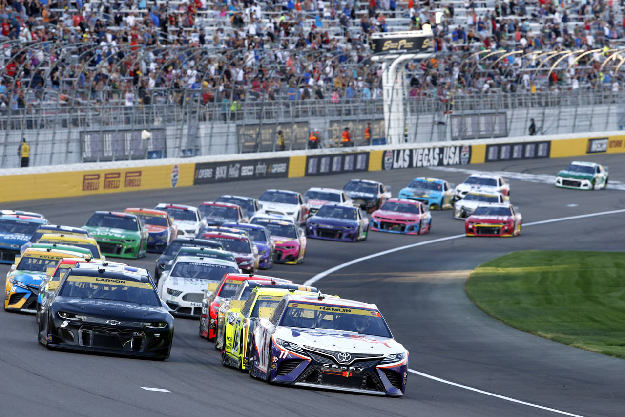 Drivers restart after a caution during a NASCAR Cup Series auto race at Las Vegas Motor Speedway. S...