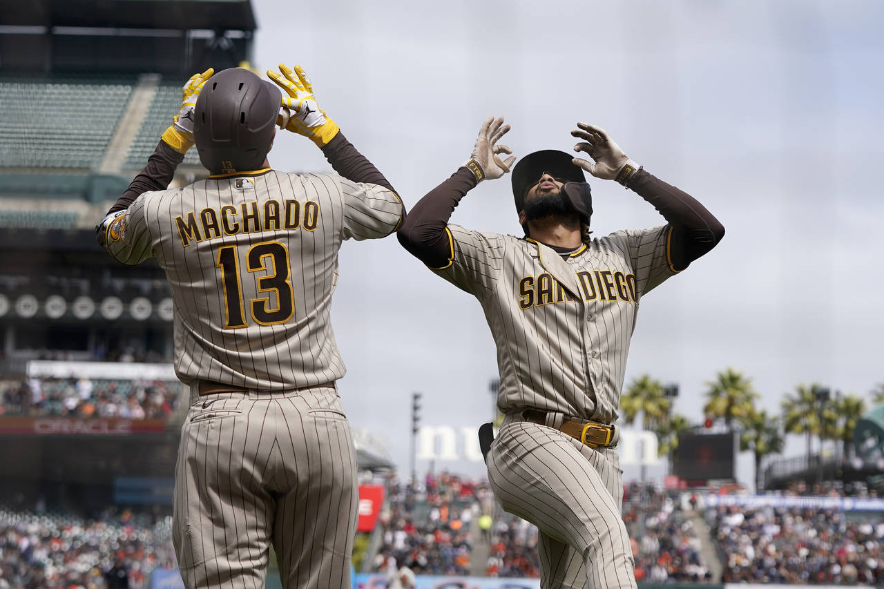 San Diego Padres' Fernando Tatis Jr., right, celebrates with Manny Machado after hitting a home run...