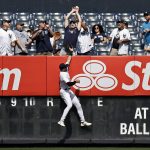 
              New York Yankees left fielder Joey Gallo jumps at the wall as a fan attempts to catch a two-run home run by Minnesota Twins' Miguel Sano during the first inning of a baseball game on Monday, Sept. 13, 2021, in New York. (AP Photo/Adam Hunger)
            