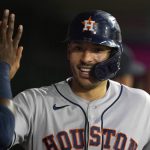 
              Houston Astros' Carlos Correa is greeted in the dugout after scoring on a two-run home run by Kyle Tucker during the second inning of a baseball game against the Los Angeles Angels Tuesday, Sept. 21, 2021, in Anaheim, Calif. (AP Photo/Marcio Jose Sanchez)
            