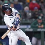
              Seattle Mariners' Mitch Haniger hits a three-run home run against the Oakland Athletics in the fourth inning of a baseball game Monday, Sept. 27, 2021, in Seattle. (AP Photo/Elaine Thompson)
            