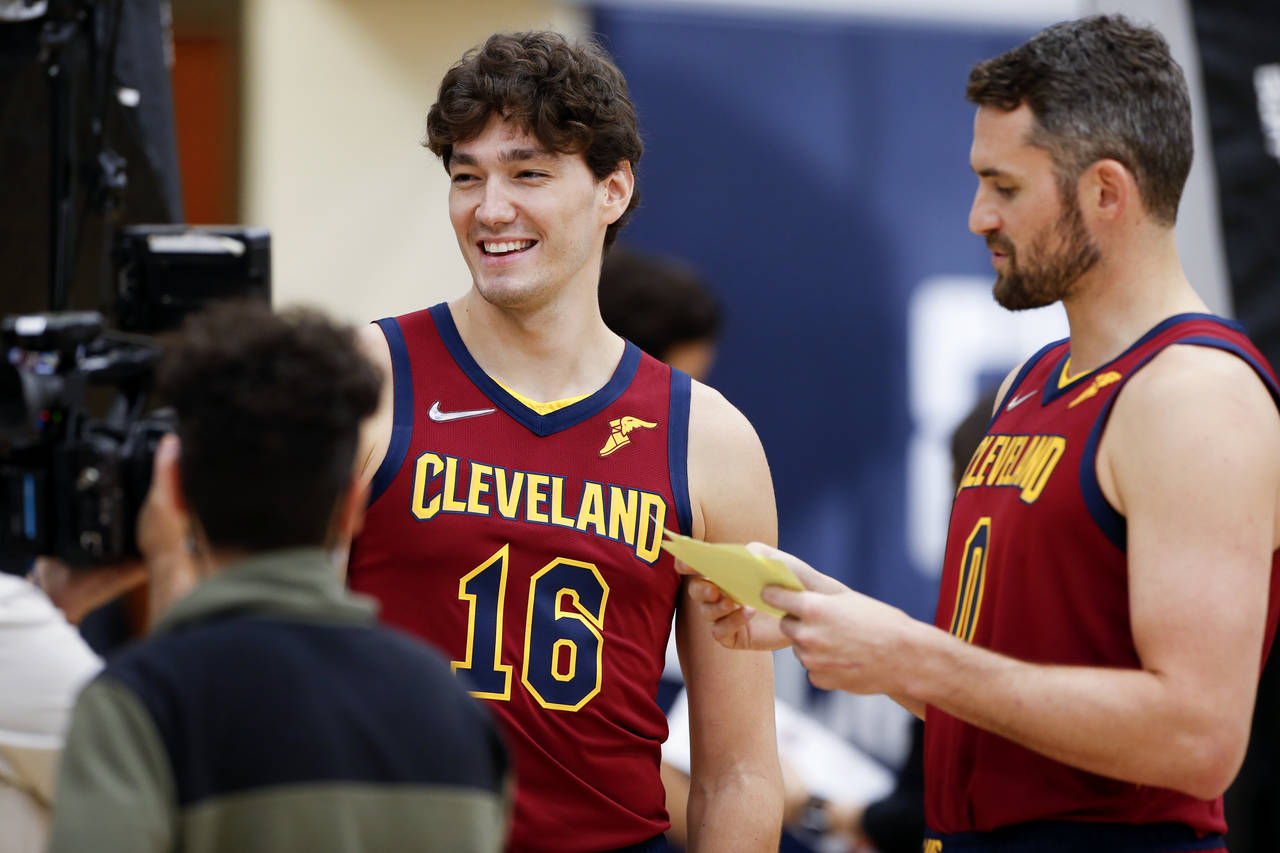 Cleveland Cavaliers' Kevin Love (0) interviews Cedi Osman (16) during the NBA basketball team's med...