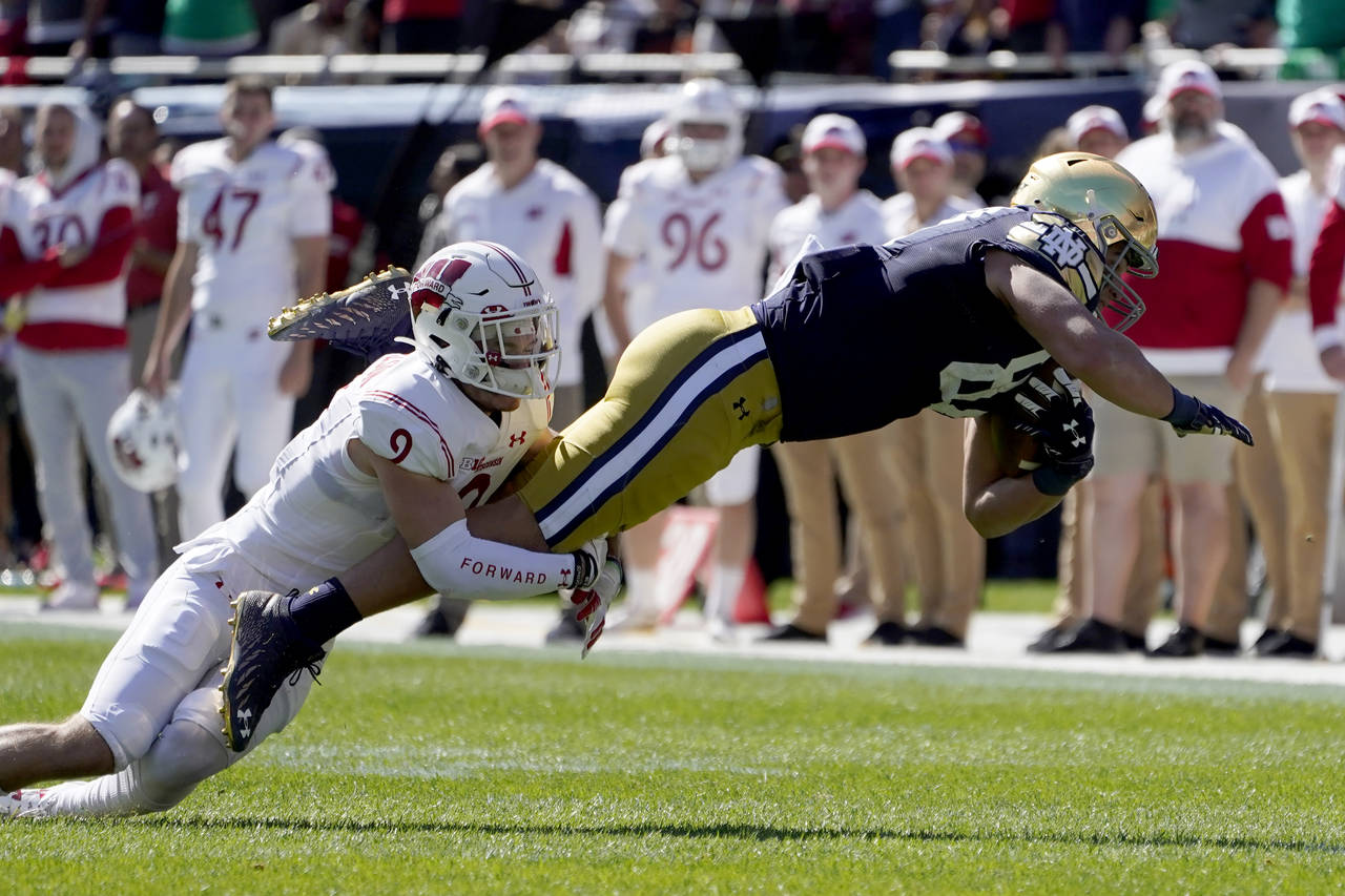 Notre Dame tight end Michael Mayer stretches out after making a catch from quarterback Jack Coan as...