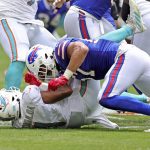 
              Miami Dolphins quarterback Tua Tagovailoa (1) is sacked by Buffalo Bills defensive end A.J. Epenesa (57) during first half of an NFL football game, Sunday, Sept. 19, 2021, in Miami Gardens, Fla. Tagovailoa was injured on the play. (David Santiago/Miami Herald via AP)
            