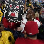 
              Fresno State wide receiver Keric Wheatfall holds a cutout of the school's mascot after a win over UCLA in an NCAA college football game Sunday, Sept. 19, 2021, in Pasadena, Calif. (AP Photo/Marcio Jose Sanchez)
            