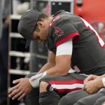 
              Tampa Bay Buccaneers quarterback Tom Brady looks down as he sits on the bench during the second half of an NFL football game against the Los Angeles Rams Sunday, Sept. 26, 2021, in Inglewood, Calif. (AP Photo/Jae C. Hong)
            