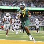 
              Baylor running back Abram Smith (7) scores a touchdown against Texas Southern in the first half of an NCAA college football game, Saturday, Sept. 11, 2021, in Waco, Texas. (Jerry Larson/Waco Tribune-Herald via AP)
            