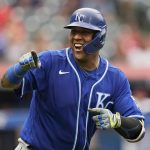 
              Kansas City Royals' Salvador Perez smiles and points to the dugout after hitting a two-run home run in the fifth inning in the first baseball game of a doubleheader against the Cleveland Indians, Monday, Sept. 20, 2021, in Cleveland. The home run broke Johnny Bench's record for the most home runs in a season by a primary catcher. (AP Photo/Tony Dejak)
            