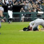 
              Oakland Athletics catcher Sean Murphy runs to starting pitcher Chris Bassitt after Bassitt was hit in the head from a ball hit by Chicago White Sox's Brian Goodwin during the second inning of a baseball game, Tuesday, Aug. 17, 2021, in Chicago. (AP Photo/Charles Rex Arbogast)
            