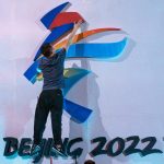 
              A crew member leaps to fix a logo for the 2022 Beijing Winter Olympics before a launch ceremony to reveal the motto for the Winter Olympics and Paralympics in Beijing, Friday, Sept. 17, 2021. Organizers on Friday announced "Together for a Shared Future" as the motto of the next Olympics, which is scheduled to begin on Feb. 4 of next year. (AP Photo/Mark Schiefelbein)
            