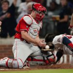 
              Atlanta Braves' Travis d'Arnaud, right, slides past Philadelphia Phillies catcher J.T. Realmuto, left, to score on a double, hit by Dansby Swanson in the fourth inning of a baseball game, Thursday, Sept. 30, 2021, in Atlanta. (AP Photo/John Bazemore)
            