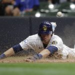 
              Milwaukee Brewers' Christian Yelich slides in safely at home after tagging up on a sacrifice fly hit by Avisail Garcia during the fifth inning of a baseball game against the New York Mets Friday, Sept. 24, 2021, in Milwaukee. (AP Photo/Aaron Gash)
            