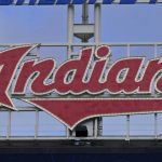 
              The Indians sign hangs at Progressive Field before the first baseball game of a doubleheader against the Chicago White Sox, Thursday, Sept. 23, 2021, in Cleveland. On Sunday, one of the American League's charter members will play its final home game of 2021, and also its last at Progressive Field as the Indians, the team's name since 1915, when "Shoeless" Joe Jackson was the starting right fielder on opening day. Much more than a late-season matchup against the Chicago White Sox, the home finale will signify the end of one era and beginning of a new chapter for the team, which will be called the Cleveland Guardians next season. (AP Photo/Tony Dejak)
            