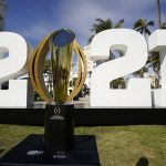 
              FILE - In this Jan. 7, 2021, file photo, the trophy for the College Football Playoff championship NCAA college football game is displayed along Ocean Drive, in Miami Beach, Fla. The College Football Playoff management committee is scheduled to meet Wednesday, Sept. 22, 2021, to discuss the feedback members have received from campuses since a 12-team expansion plan was unveiled in June. (AP Photo/Lynne Sladky, File)
            