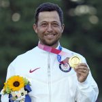 
              FILE - In this Aug. 1, 2021, file photo, Xander Schauffele, of the United States, holds his gold medal in the men's golf at the 2020 Summer Olympics in Kawagoe, Japan. The 2020 US Ryder Cup team has six rookies, including gold medalist Xander Schauffele. (AP Photo/Andy Wong, File)
            