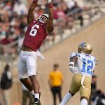 
              Stanford wide receiver Elijah Higgins (6) catches a pass over UCLA defensive back Martell Irby (12) during the first half of an NCAA college football game Saturday, Sept. 25, 2021, in Stanford, Calif. (AP Photo/Tony Avelar)
            