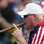 
              A fan smokes a large cigar on the 10th hole during a practice day at the Ryder Cup at the Whistling Straits Golf Course Wednesday, Sept. 22, 2021, in Sheboygan, Wis. (AP Photo/Ashley Landis)
            