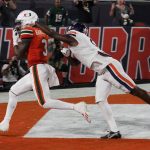 
              Miami wide receiver Mike Harley (3) grabs a touchdown pass in the end zone ahead of a tackle by Virginia defensive back Coen King, during the second half of a NCAA college football game, Thursday, Sept. 30, 2021, in Miami Gardens, Fla. (AP Photo/Marta Lavandier)
            
