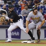 
              Pittsburgh Pirates' Bryan Reynolds, right, stands at third after advancing on a double by Anthony Alford during the third inning of a baseball game, Saturday, Sept. 18, 2021, in Miami. Miami Marlins shortstop Eddy Alvarez is at left. (AP Photo/Marta Lavandier)
            