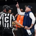 
              Georgia Tech head coach Geoff Collins points to the video board as he argues with officials during the second half of an NCAA college football game against North Carolina Saturday, Sept. 25, 2021, in Atlanta. (AP Photo/John Bazemore)
            
