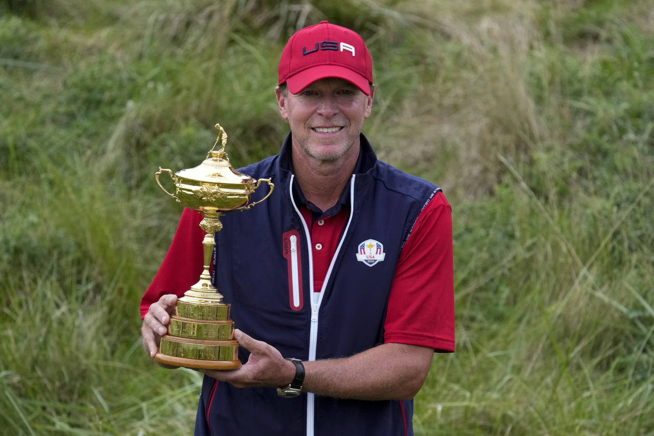 Team USA captain Steve Stricker poses with the trophy after the Ryder Cup matches at the Whistling ...