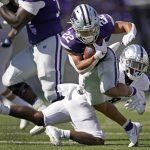 
              Kansas State running back Deuce Vaughn (22) gets past Nevada defensive back JoJuan Claiborne on a run during the second half of an NCAA college football game Saturday, Sept. 18, 2021, in Manhattan, Kan. (AP Photo/Charlie Riedel)
            
