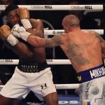
              Oleksandr Usyk of Ukraine hits Anthony Joshua of Britain during their WBA (Super), WBO and IBF boxing title bout at the Tottenham Hotspur Stadium in London, Saturday, Sept. 25, 2021. (AP Photo/Frank Augstein)
            