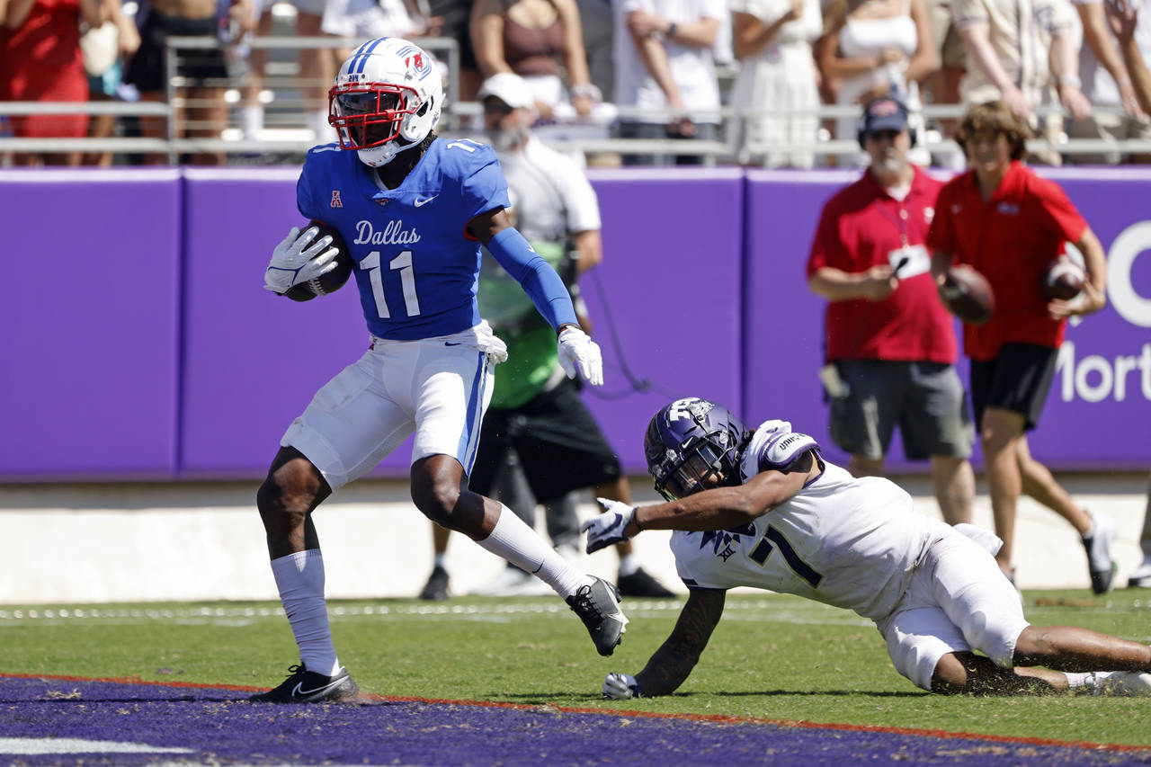 SMU wide receiver Rashee Rice (11) scores a touchdown in front of TCU safety T.J. Carter (7) during...