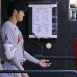 
              Los Angeles Angels designated hitter Shohei Ohtani, of Japan, plays with a ball in the dugout during the second inning of a baseball game against the Chicago White Sox in Chicago, Thursday, Sept. 16, 2021. (AP Photo/Nam Y. Huh)
            