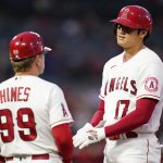 
              Los Angeles Angels designated hitter Shohei Ohtani (17) talks with first base coach Bruce Hines (99) at first base during the first inning of a baseball game against the Oakland Athletics Friday, Sept. 17, 2021, in Anaheim, Calif. (AP Photo/Ashley Landis)
            