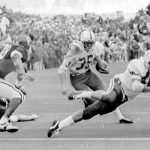 
              FILE - In this Nov. 25, 1971, file photo, Nebraska's Jeff Kinney (35) gets a block from fullback Maury Damkroger (46) as he scores against Oklahoma from the two-yard line with 1:38 left in a college football game in Norman, Okla., on Thanksgiving Day. The game on Thanksgiving 50 years ago is back in the spotlight as Nebraska and Oklahoma renew their rivalry on Saturday, Sept. 18, 2021. (Tulsa World via AP, File)
            