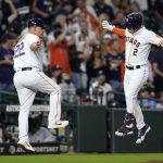 
              Houston Astros' Alex Bregman (2) celebrates with third base coach Omar Lopez after hitting a home run against the Tampa Bay Rays during the sixth inning of a baseball game Tuesday, Sept. 28, 2021, in Houston. (AP Photo/David J. Phillip)
            
