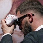 
              Undefeated IBF Super Middleweight Champion Caleb Plant wipes his head after being cut in a scuffle with unified WBC/WBO/WBA super middleweight champion Canelo Alvarez during a news conference Tuesday, Sept. 21, 2021, in Beverly Hills, Calif. to announce their 168-pound title bout. The fight is scheduled for Saturday, Nov. 6 in Las Vegas. (AP Photo/Mark J. Terrill)
            