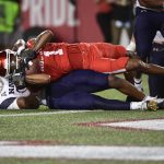 
              Houston wide receiver Nathaniel Dell (1) is tackled by Navy cornerback Jamal Glenn (16) during the second half of an NCAA college football game, Saturday, Sept. 25, 2021, in Houston. (AP Photo/Justin Rex)
            