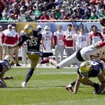 
              Notre Dame place kicker Jonathan Doerer kicks a field goal off the hold of Jay Bramblett during the first half of an NCAA college football game against Wisconsin Saturday, Sept. 25, 2021, in Chicago. (AP Photo/Charles Rex Arbogast)
            