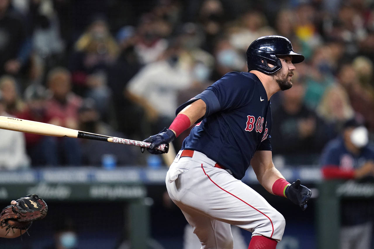 Boston Red Sox's Kyle Schwarber watches his three-run double against the Seattle Mariners during th...