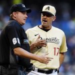 
              Arizona Diamondbacks manager Torey Lovullo (17) argues with umpire Chad Whitson, left, during the third inning of a baseball game against the Los Angeles Dodgers Saturday, Sept. 25, 2021, in Phoenix. (AP Photo/Ross D. Franklin)
            