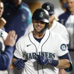 
              Seattle Mariners' Mitch Haniger celebrates in the dugout after hitting a solo home run in the seventh inning of a baseball game against the Oakland Athletics Tuesday, Sept. 28, 2021, in Seattle. (AP Photo/Jason Redmond)
            