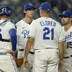 
              Kansas City Royals pitching coach Cal Eldred (21) talks to starting pitcher Daniel Lynch, second from left, during the fourth inning of a baseball game against the Cleveland Indians Wednesday, Sept. 29, 2021, in Kansas City, Mo. (AP Photo/Charlie Riedel)
            