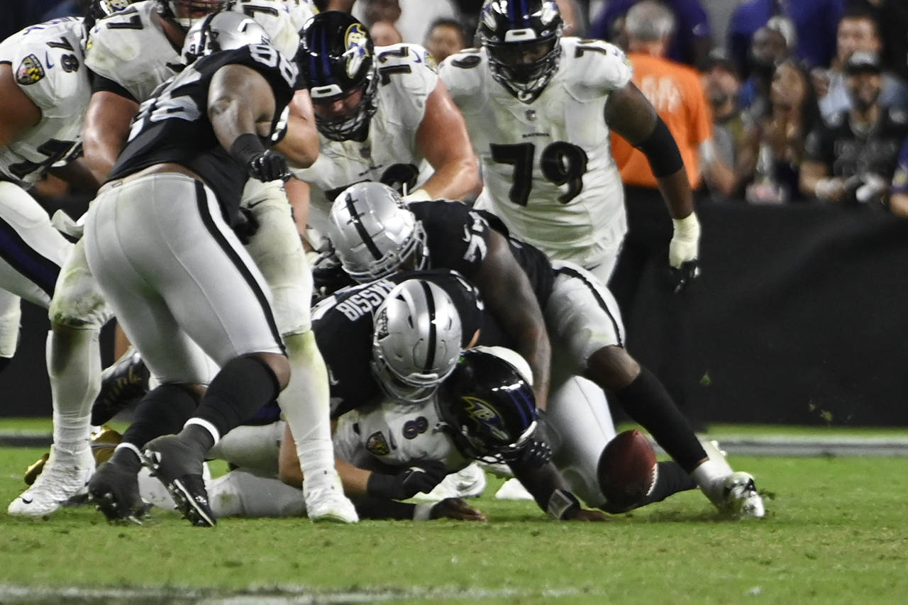 Raiders defensive end Carl Nassib (94) celebrates after beating the  Baltimore Ravens in overtim …