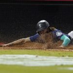 
              Seattle Mariners' J.P. Crawford scores on a sacrifice fly hit by Mitch Haniger during the seventh inning of a baseball game against the Los Angeles Angels Friday, Sept. 24, 2021, in Anaheim, Calif. (AP Photo/Mark J. Terrill)
            