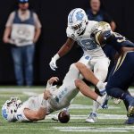 
              North Carolina quarterback Sam Howell (7) loses the ball after being hit by Georgia Tech defensive lineman Ja'Quon Griffin (95) during the first half of an NCAA college football game Saturday, Sept. 25, 2021, in Atlanta. Murphy recovered his fumble. (AP Photo/John Bazemore)
            