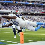 
              Los Angeles Chargers wide receiver Mike Williams lunges into the end zone for a touchdown during the first half of an NFL football game against the Dallas Cowboys Sunday, Sept. 19, 2021, in Inglewood, Calif. (AP Photo/Ashley Landis)
            