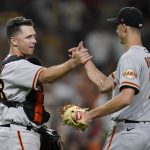 
              San Francisco Giants catcher Buster Posey, left, celebrates with relief pitcher Tyler Rogers after the Giants defeated the San Diego Padres 6-5 in a baseball game Tuesday, Sept. 21, 2021, in San Diego. (AP Photo/Gregory Bull)
            
